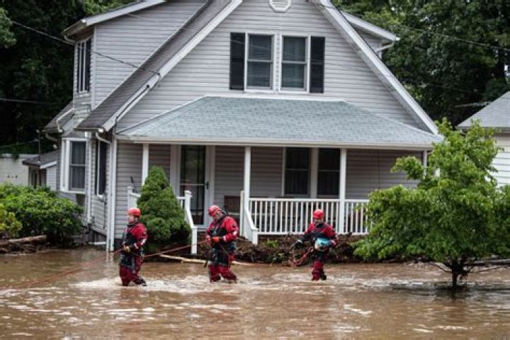 
Hurricane Ian Flood Waters Leave Fla. Driver Stranded: See Rescue Workers Pull Woman from Her Car 